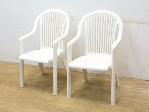 Versatile white plastic chairs offering comfort and style for indoor and outdoor settings.