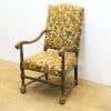 Charming vintage armchair with floral upholstery and sturdy wooden frame, perfect for cozy decor.