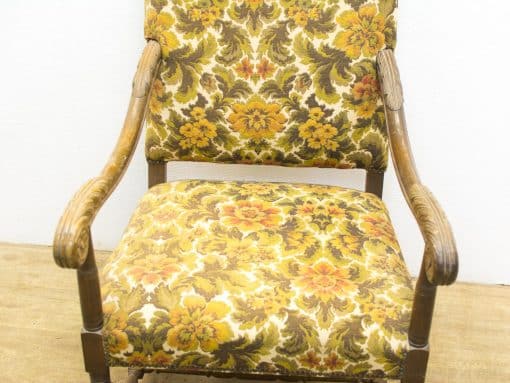 Charming vintage floral armchair with wooden frame, perfect for stylish and cozy interiors.