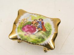 Elegant trinket box with gold finish and romantic couple painting, perfect for home decor.