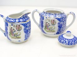 Elegant blue and white porcelain creamer and sugar bowl set for refined tea service.