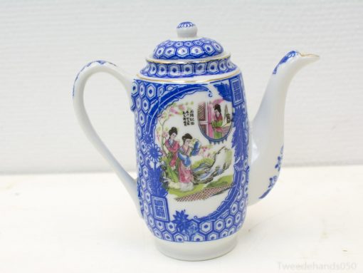 Elegant blue-and-white porcelain teapot with intricate designs, ideal for tea and decoration.