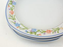 Elegant floral porcelain plates with blue accents, perfect for stylish dining and special occasions.