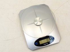 Sleek digital kitchen scale with glass top, perfect for precise cooking and baking measurements.