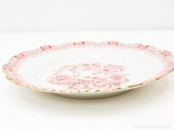 Elegant porcelain plate with red floral designs and gold scalloped rim for sophisticated table decor.