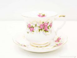 Elegant tea cup with pink roses and gold trim, perfect for tea parties and displays.