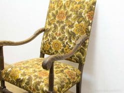 Vintage floral armchair with elegant wood detailing for timeless home decor.