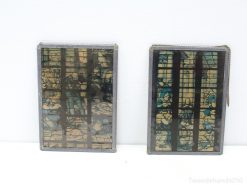 Vintage stained glass panels in earthy tones and vibrant blue, perfect for unique home decor.