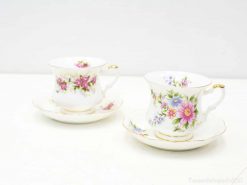 Elegant vintage teacups with floral designs and gold accents, perfect for sophisticated tea gatherings.