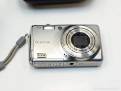 Sleek silver Fujifilm camera with 10x zoom, perfect for travel photography adventures.