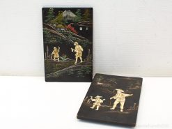 Decorative wooden panels showcasing detailed rural scenes and traditional craftsmanship.