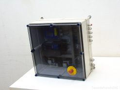 Compact industrial control unit with emergency stop button and transparent casing for easy monitoring.