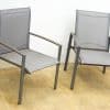 Stylish gray outdoor chairs with metal frames and breathable mesh for comfortable relaxation.