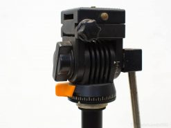 Professional tripod head with ergonomic controls for precise camera positioning and stability.