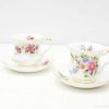 Elegant vintage teacups with floral designs and gold accents, perfect for sophisticated tea gatherings.