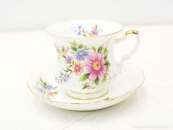 Elegant floral teacup and saucer set with gold trim, perfect for sophisticated gatherings.