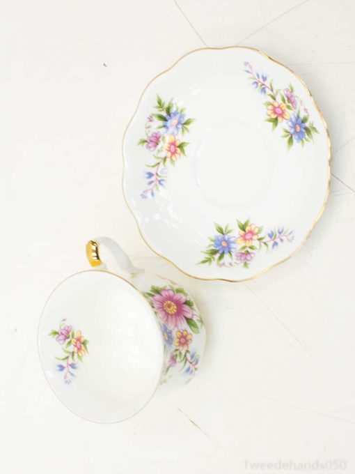 Elegant floral tea cup and saucer with gold trim, ideal for sophisticated tea occasions.