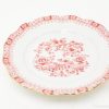 Elegant porcelain plate with red floral pattern and gold trim, perfect for special occasions.