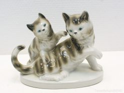 Charming porcelain cat figurine showcasing playful friendship, ideal for collectors and feline enthusiasts.