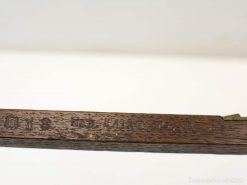 Antique wooden ruler with engravings and metal accents, exemplifying fine craftsmanship and history.