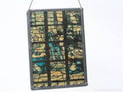 Vibrant stained glass panel illustrating historical narratives in deep blue hues.