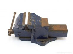 Durable vintage blue bench vise, showcasing wear and perfect for securely holding materials.