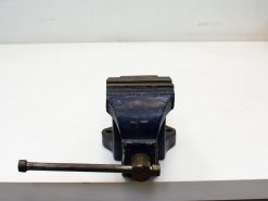 Vintage blue bench vise for secure gripping in woodworking and metalworking projects.