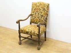 Charming vintage armchair with floral upholstery and sturdy wooden frame, perfect for cozy decor.