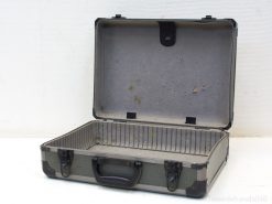 Vintage gray suitcase with spacious interior, durable design, and rich travel history.