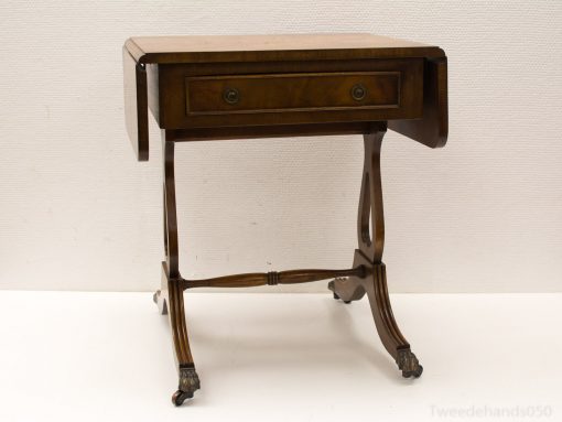 Elegant antique drop-leaf table with storage drawer, perfect for versatile vintage-inspired interiors.