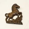 Elegant bronze horse sculpture, beautifully detailed with floral base, perfect for equestrian decor.