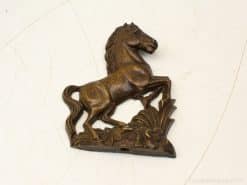 Elegant bronze horse sculpture, beautifully detailed with floral base, perfect for equestrian decor.