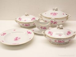 Elegant porcelain dish set with pink flowers and gold trim for refined dining experiences.