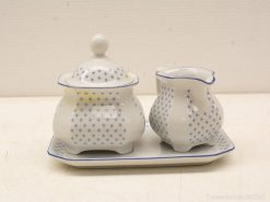 Timeless blue-and-white porcelain sugar bowl and creamer set for elegant dining moments.