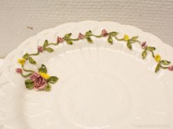 Elegant white ceramic plate with hand-painted floral design, ideal for dining and decor.