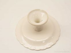 Elegant white porcelain candle holder with scalloped base, perfect for vintage décor and stylish settings.