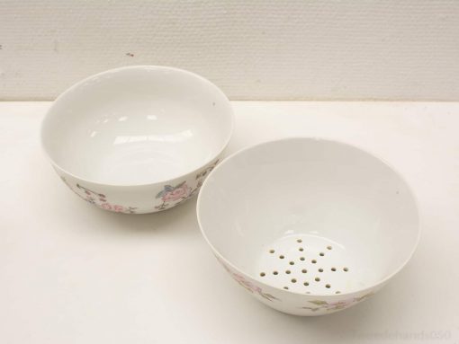 Elegant porcelain mixing bowl and colander with floral design for stylish kitchen use.