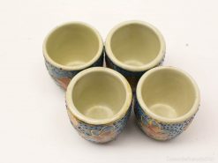 Charming handmade floral ceramic cups, perfect for serving drinks or as decorative accents.