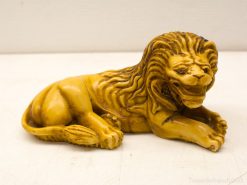 Intricate yellow lion sculpture, showcasing elegance and strength, perfect for decor or collection.