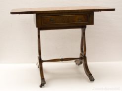 Elegant vintage wooden table with drawer and wheels, ideal for versatile home decor.