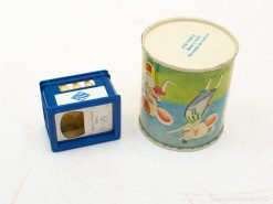 Vintage blue box and colorful tin evoke joyful childhood memories and playful nostalgia.