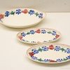 Charming vintage ceramic platters with vibrant floral designs, perfect for serving or decoration.