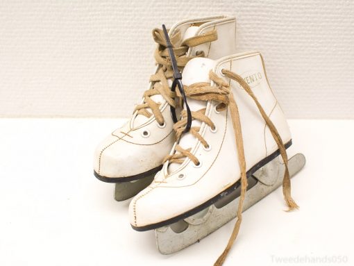 Vintage white ice skates with glossy blades, perfect for skating enthusiasts and winter memories.