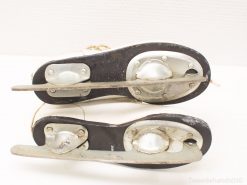 Vintage leather ice skates with character, showcasing well-worn metal blades and rich history.