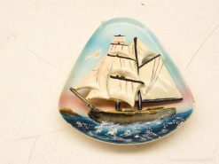 Vintage sailing ship decor with intricate waves, perfect for nautical enthusiasts and collectors.