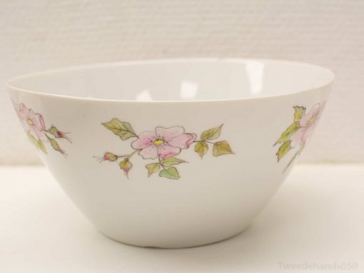 Elegant white porcelain bowl with delicate floral design, ideal for dining and home decor.