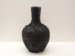 Elegant black vase with textured finish and shimmering accents for modern decor.