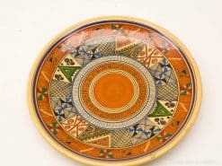 Vibrant geometric ceramic plate with intricate designs, perfect for decor and cultural display.