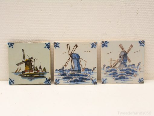 Ceramic tiles featuring traditional Dutch windmills in serene blue and earthy tones.