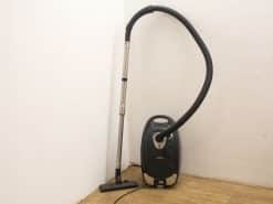 Stylish black vacuum cleaner with silver accents, perfect for modern homes and efficient cleaning.